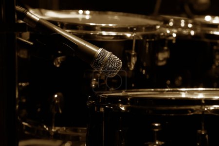 Drum set on stage in a concert hall. Large-sized photo with soft change selectivity. Vintage live music background