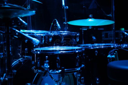 Drum set on stage in a concert hall. Large-sized photo with soft change selectivity. Vintage live music background