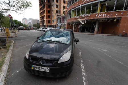 Photo for ODESSA, UKRAINE - July 14, 2023: War in Ukraine. A destroyed civilian building and civilian vehicles after rocket attack. Ruins of war with Ukraine. Russian military special operation. War damaged car - Royalty Free Image