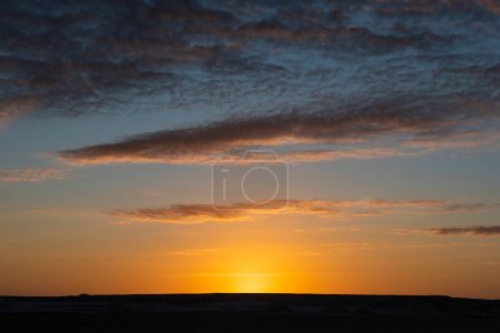 Landscape scenic view of desolate barren western desert in Panoramic barren landscape in Egypt Western White desert with sunrise against cloudy sky background