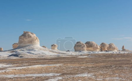 Landscape scenic view of desolate barren western white desert in Egypt with geological chalk rock formations
