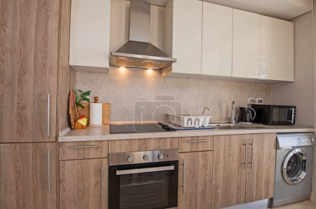 Interior design decor showing modern kitchen and appliances in luxury apartment showroom with extractor fan