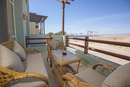 Terrace furniture of a luxury apartment in tropical resort with furniture and sea view from balcony