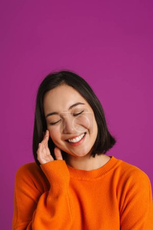 Photo for Young asian woman wearing sweater laughing with eyes closed isolated over purple background - Royalty Free Image