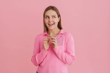 Photo for Young beautiful white woman wearing shirt smiling and think of trick standing isolated over pink background - Royalty Free Image