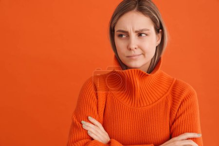 Photo for Young beautiful white woman wearing sweater frowning and looking sad standing isolated over red background - Royalty Free Image