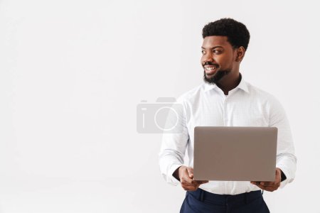 Photo for Black bearded man wearing shirt smiling and working with laptop isolated over white background - Royalty Free Image