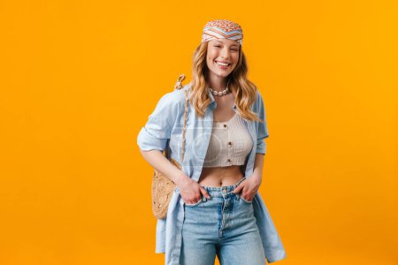 Photo for Young blonde woman wearing bandanna smiling and looking at camera isolated over yellow background - Royalty Free Image