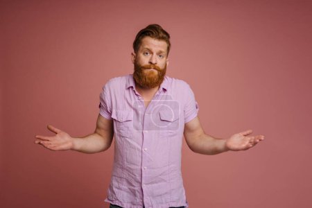 Photo for Ginger white man with beard looking and gesturing at camera isolated over pink background - Royalty Free Image