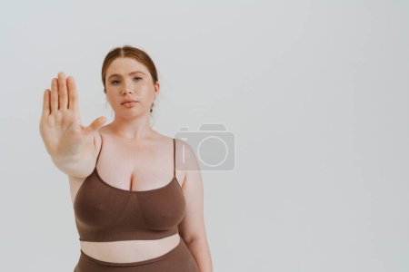 Photo for European woman with ginger hair showing stop gesture isolated over white background - Royalty Free Image