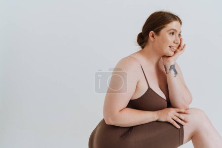 Photo for European woman smiling and posing while standing isolated over white background - Royalty Free Image