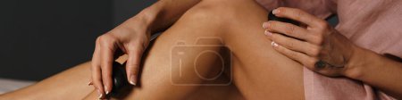 Téléchargez les photos : Femme blanche faisant un traitement spa des pieds avec des pierres à l'intérieur - en image libre de droit
