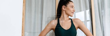 Photo for White brunette woman doing exercise while working out at home - Royalty Free Image