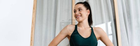 Photo for White brunette woman smiling and doing exercise while working out at home - Royalty Free Image
