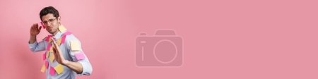Photo for Young white man with stickers gesturing and looking at camera isolated over pink background - Royalty Free Image