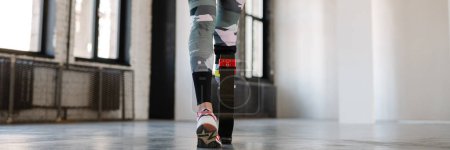 Photo for Young sportswoman with prosthesis working out indoors - Royalty Free Image