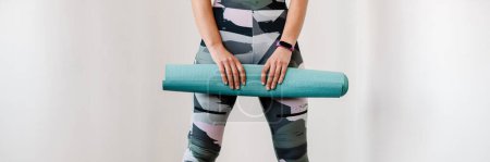 Photo for Young sportswoman with prosthesis posing with fitness mat indoors - Royalty Free Image