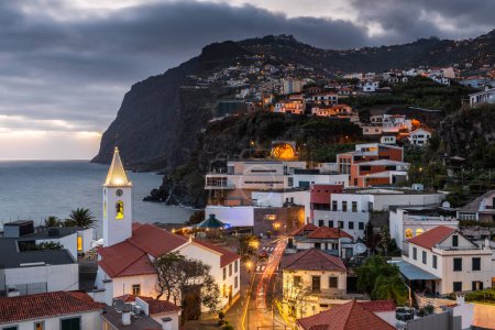 Photo for Cityscape of Camara de Lobos at dusk illuminated architecture of the seaside town in Madeira island, Portugal - Royalty Free Image