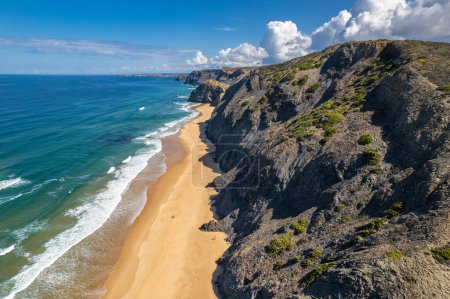 Aerial drone view of Cordoama Beach in Portugal with sandy shore, cliffs and ocean