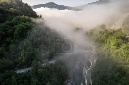 Foggy sunrise over Soca river near Kobarid in Slovenia, aerial drone view