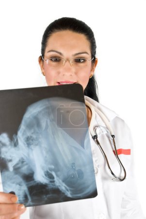 Smiling doctor analyze a head x-ray and all things are OK