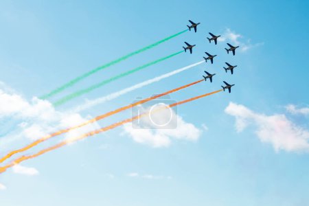 Téléchargez les photos : Squadron of planes fly with color trail lines of Ireland, Italy, Iran, Hungary over clouds and clear sky - en image libre de droit