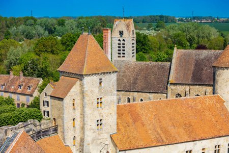 Photo for Medieval castle tower and walls Blandy-les-Tours, France over Saint-Maurice church - Royalty Free Image
