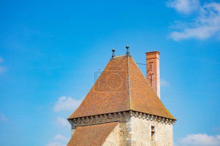 Photo for Close image of medieval castle square tower roof over blue sky, Blandy-les-Tours, France - Royalty Free Image