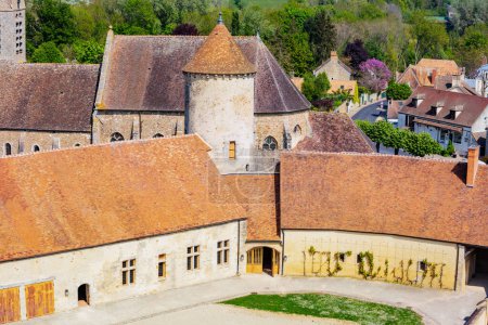 Foto de Medieval castle tower and walls Blandy-les-Tours court, France over Saint-Maurice church - Imagen libre de derechos