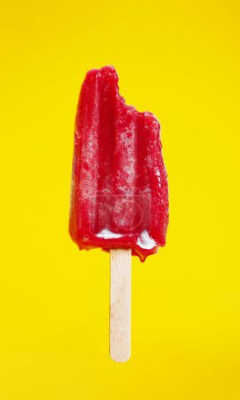 Foto de Dripping cold ice cream during hot summer weather isolated on yellow concept - Imagen libre de derechos