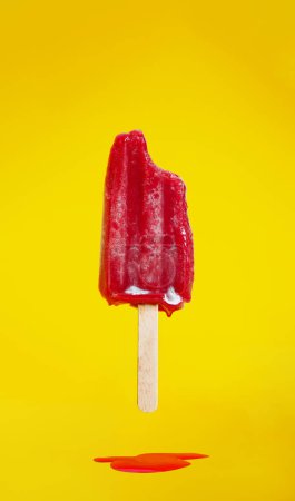 Photo for Dripping cold ice cream during hot summer weather over yellow background - Royalty Free Image