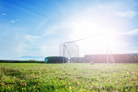 Photo for Garden's football gates are set against the backdrop of a clear blue sky, blazing hot summer sun: picturesque scene of nature and sport - Royalty Free Image