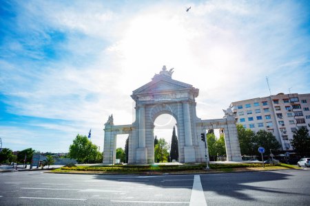 Photo for Majestic San Vicente Gate in Madrid with Roundabout on sunny summer day and city street view - Royalty Free Image