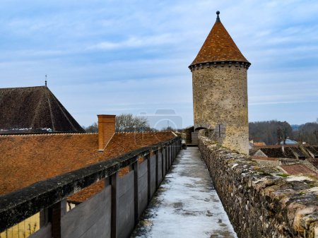 Photo for Panorama of the walls covered with snow on old tower of Blandy-les-Tours castle on sunny day over blue sky, France Europe - Royalty Free Image