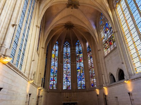 Photo for Interior of Sainte-Chapelle de Vincennes, France, with sunlight passing through vibrant stained glass glazing - Royalty Free Image