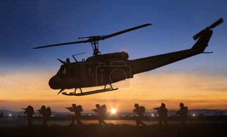 Military special forces helicopter drops operation at sunset