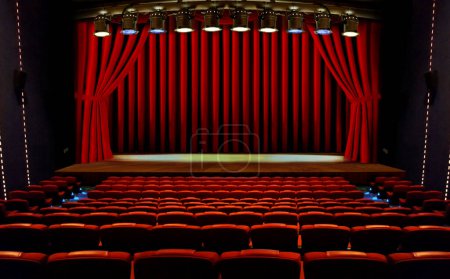 theater stage with red curtains and seats under spotlights