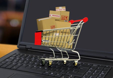 Foto de Concepto de servicio de compras y entrega en línea con carrito de compras lleno de cajas en el ordenador portátil - Imagen libre de derechos
