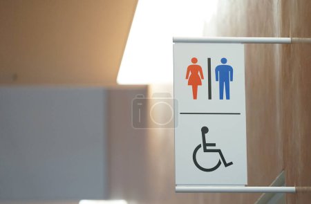 Photo for Signs on the wall guiding the location of indoor restrooms - Royalty Free Image