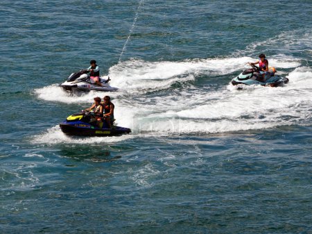 Photo for SE Florida if not already, is fast becoming ,the jet ski capitol of the world.  Shown here four teen aged jet-skiers enjoying a Saturday afternoon. outing on the Florida Intracoastal Waterway off of Miami Beach on 23 October 203. - Royalty Free Image