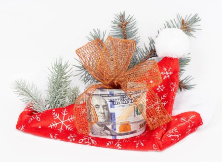 Photo for Santa hat and money on white background with pine branch - Royalty Free Image