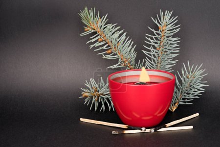 Photo for Candle with pine branch on a black background - Royalty Free Image