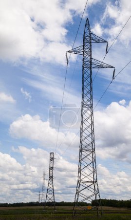 Photo for Electricity Pylon power line transmission tower at sunset. High voltage tower with electric power lines transfening electrical energy through cable wires. - Royalty Free Image