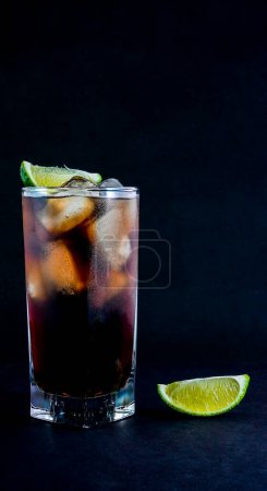 Photo for Cuba Libre drink on black background with copy or text space - Royalty Free Image