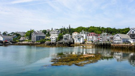 Photo for STONINGTON, MAINE, USA - JULY 13, 2023:  Beautiful view in Stonington with buildings, sky and ocean reflection - Royalty Free Image