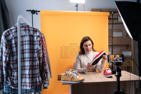 Photo for Woman blogger or vlogger looking at camera reviewing product. Modern businesswoman using social media for marketing. Business online influencer concept. copy space - Royalty Free Image
