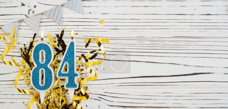 Photo for Number 84 blue celebration candle on white wooden background. Happy birthday candles. Concept of celebrating birthday, anniversary, important date, holiday. Copy space. Banner - Royalty Free Image