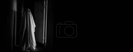 Photo for Ghost figure - Halloween spirit, haunting in abandoned house. Banner. Copy space. Black and white - Royalty Free Image