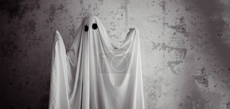 Photo for White ghost with black eyes, made from a bedsheet. Banner. Copy space - Royalty Free Image