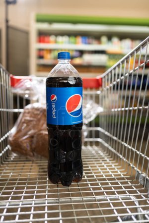 Photo for Odessa, Ukraine - 1 September 2023 : PEPSI bottle drink in supermarket trolley. Pepsi is a famous cola drink. Copy space - Royalty Free Image
